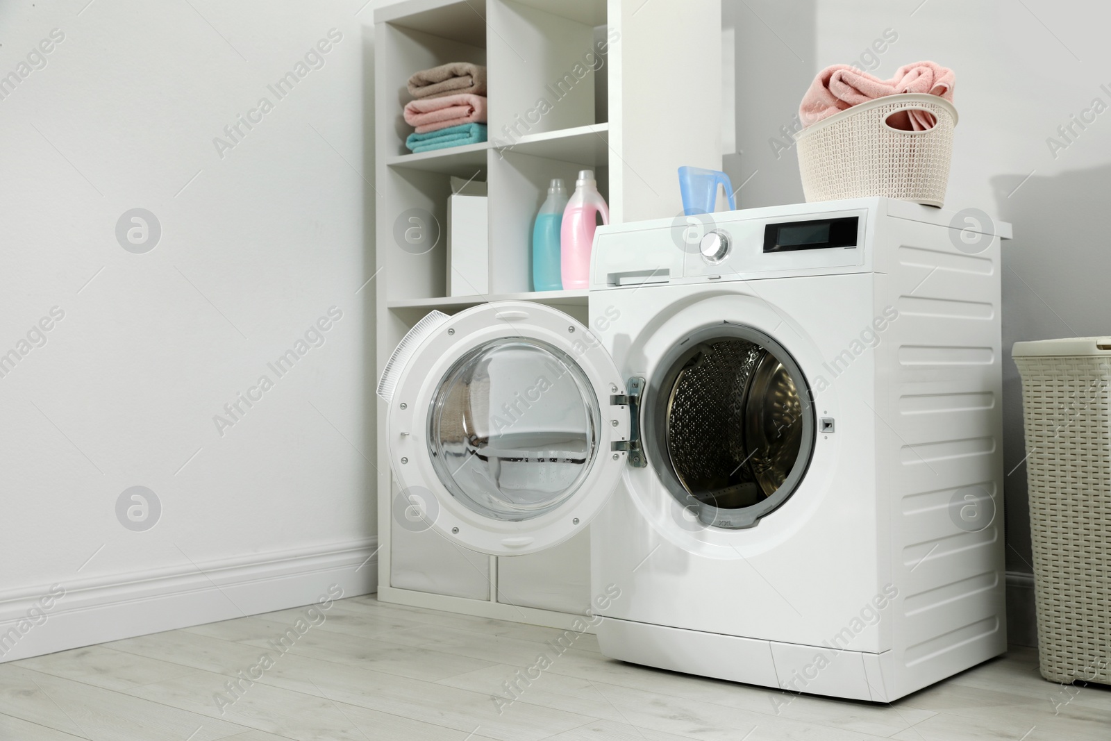 Photo of Modern washing machine in laundry room interior. Space for design