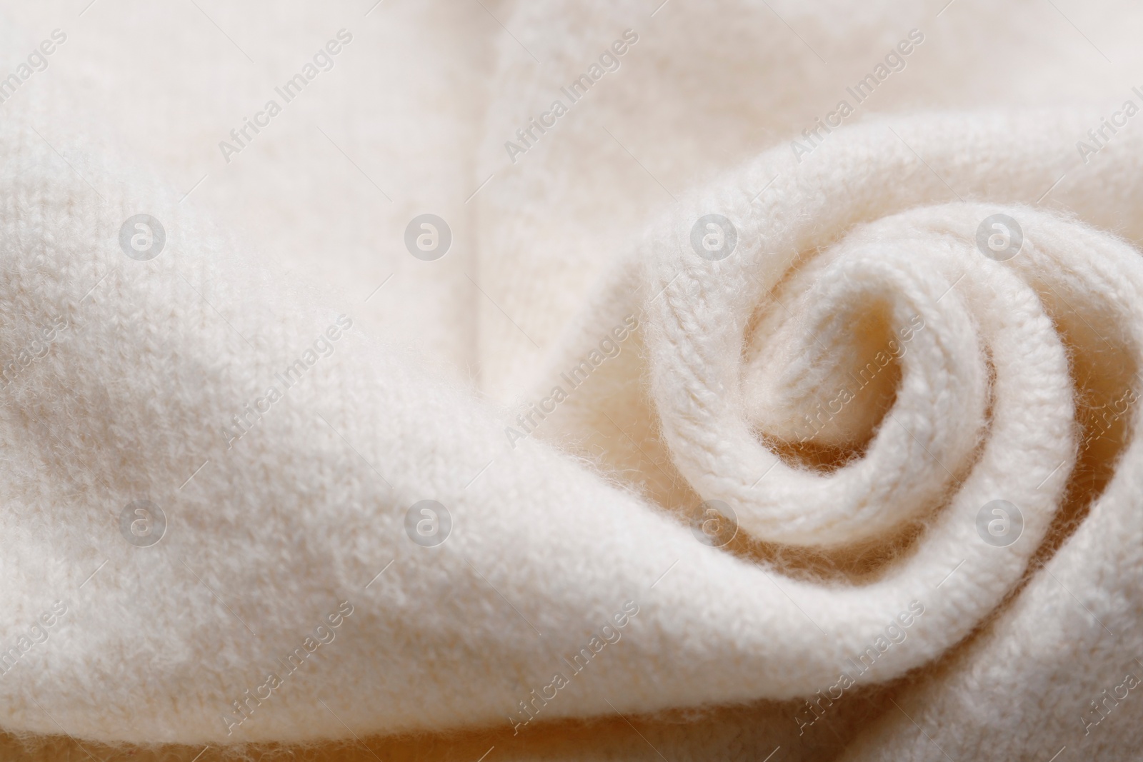 Photo of Soft beige knitted fabric as background, top view