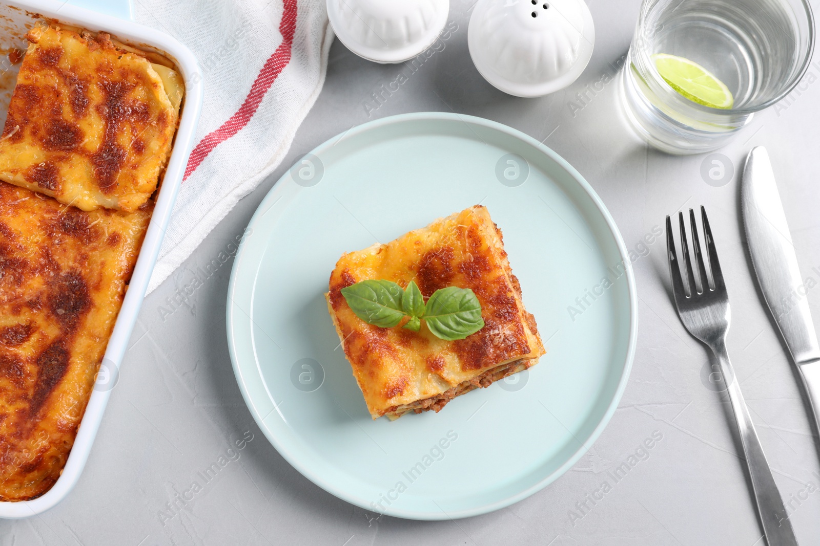 Photo of Tasty cooked lasagna served on grey table, flat lay