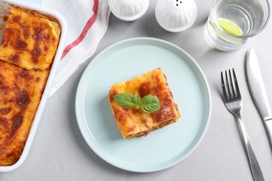 Tasty cooked lasagna served on grey table, flat lay