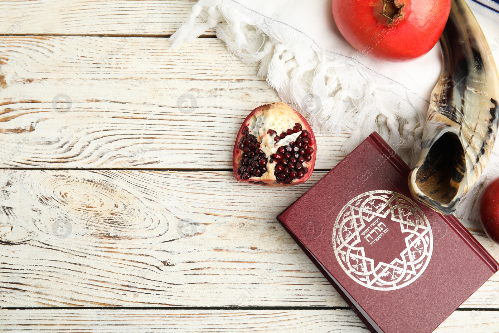 Photo of Flat lay composition with Rosh Hashanah holiday symbols on white wooden table. Space for text