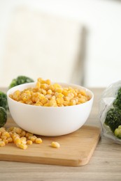 Frozen vegetables on wooden table indoors, closeup. Space for text