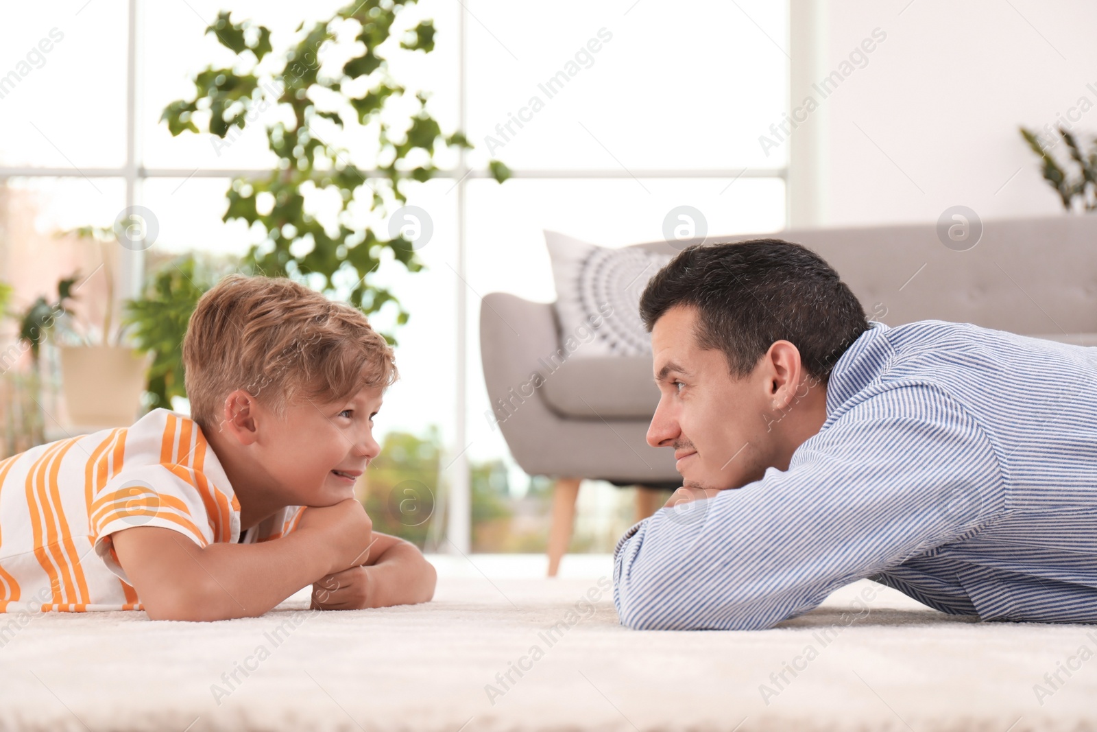 Photo of Father with cute child on floor at home. Happy family