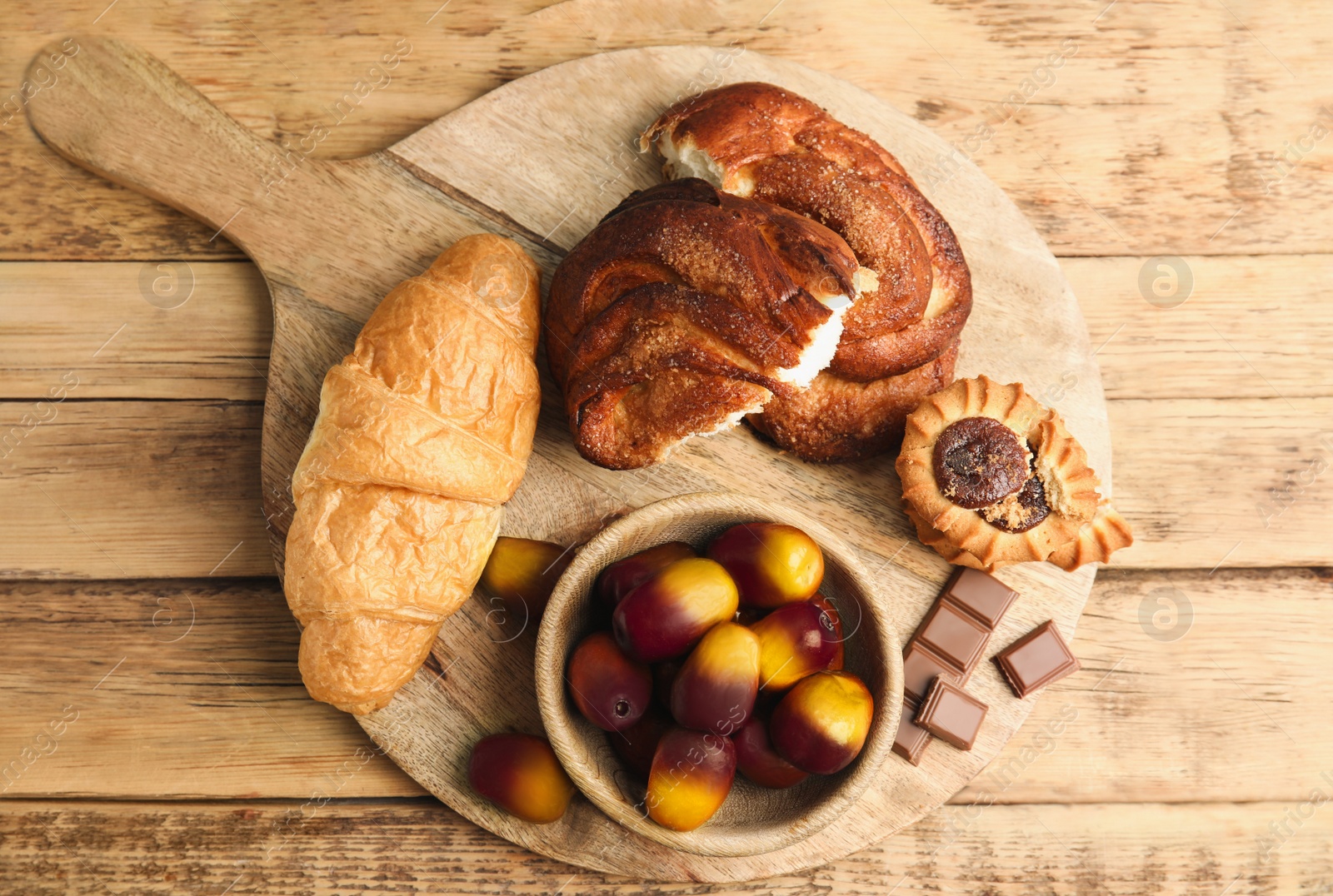 Image of Fresh ripe palm oil fruits and sweets on wooden table, top view