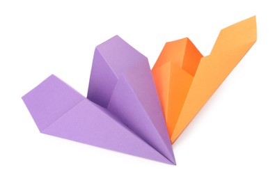 Photo of Handmade purple and orange paper planes isolated on white