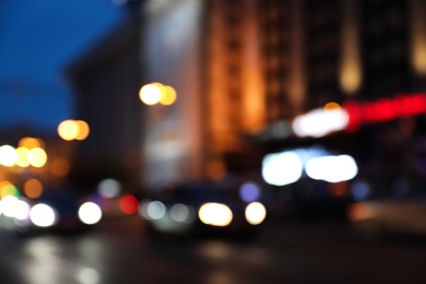 Photo of Blurred view of modern city at evening. Bokeh effect