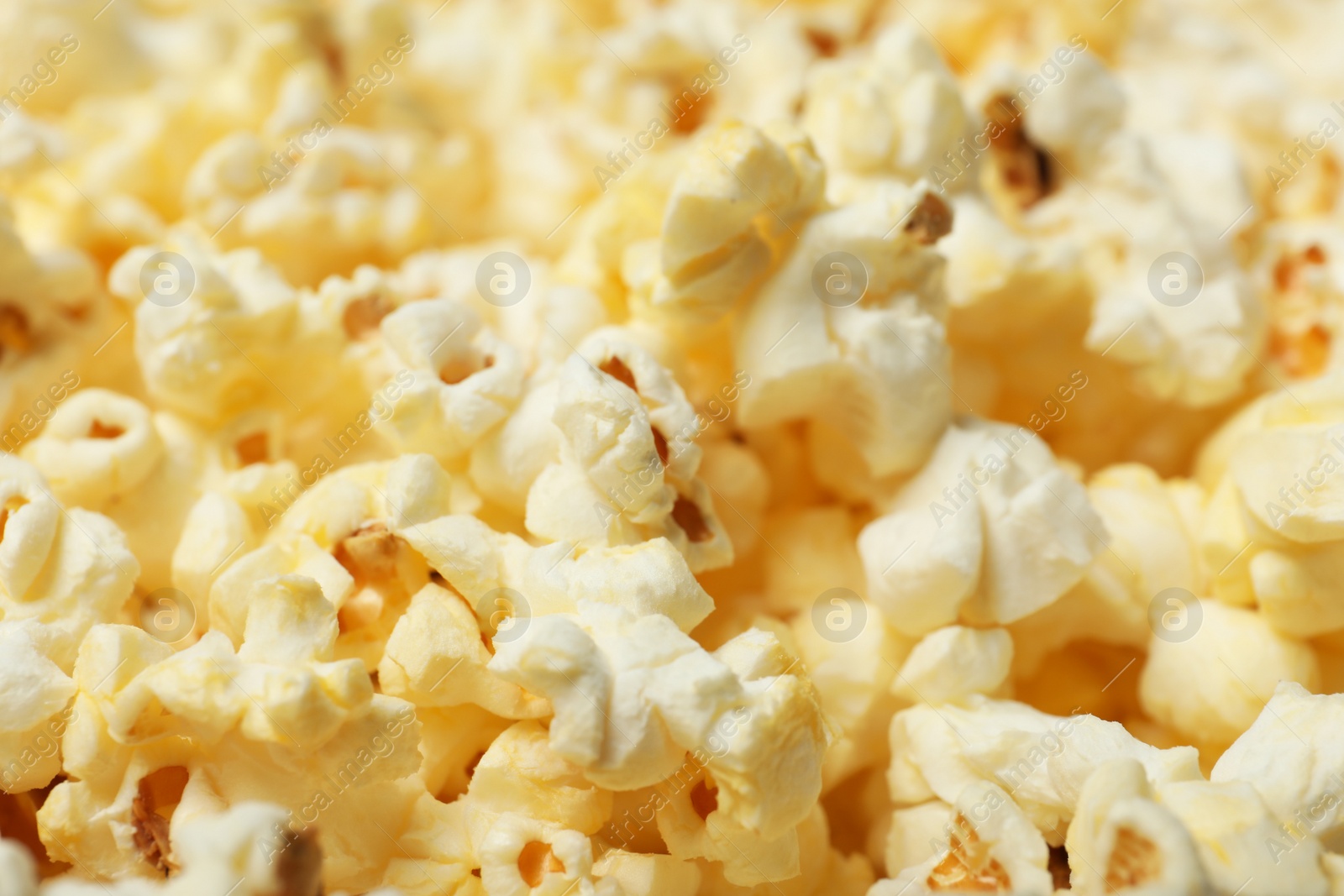 Photo of Fresh popcorn as background, closeup. Tasty snack