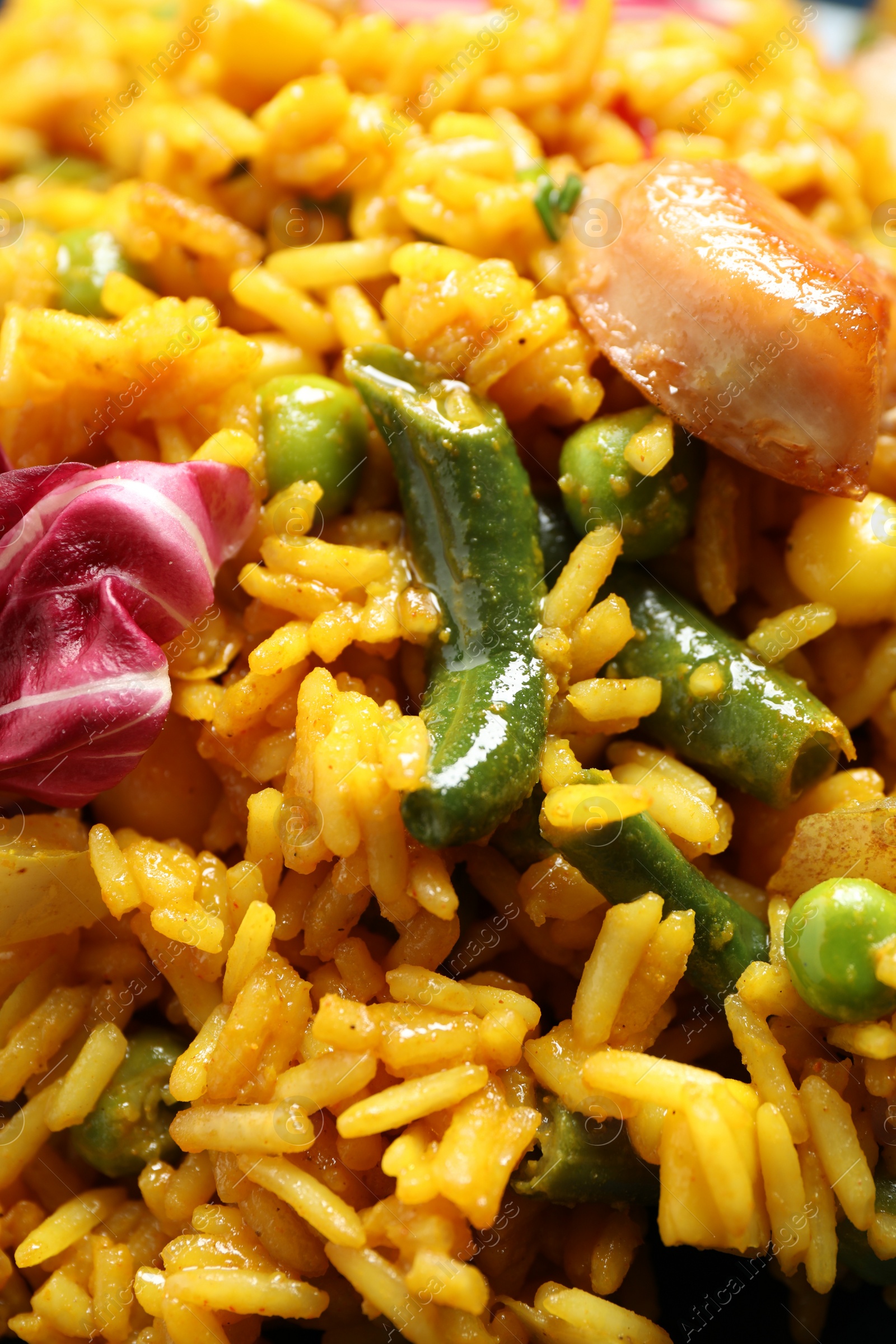 Photo of Delicious rice pilaf with chicken and vegetables as background, closeup