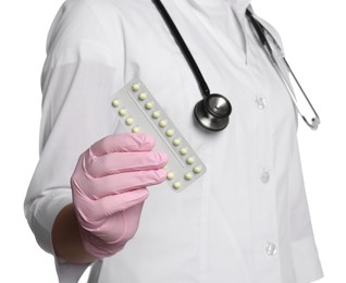 Doctor holding blister of oral contraception pills on white background, closeup