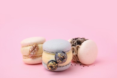Photo of Delicious sweet macarons on pink background, closeup