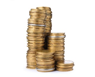Many golden coins stacked on white background