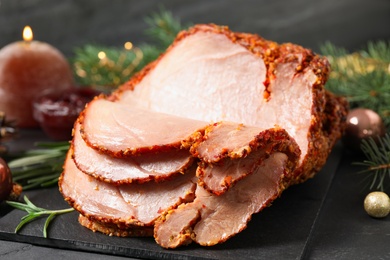 Delicious Christmas ham served on dark table