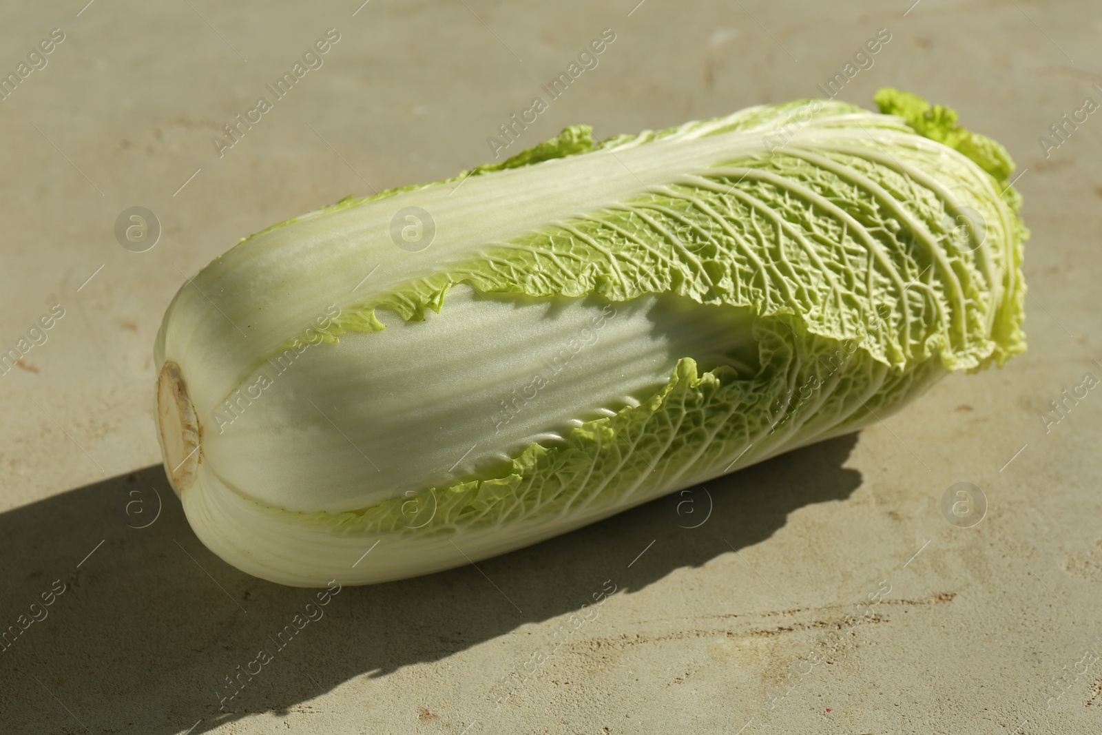 Photo of Fresh ripe Chinese cabbage on gray textured table, closeup