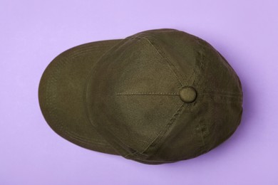 Photo of Baseball cap on violet background, top view. Mock up for design