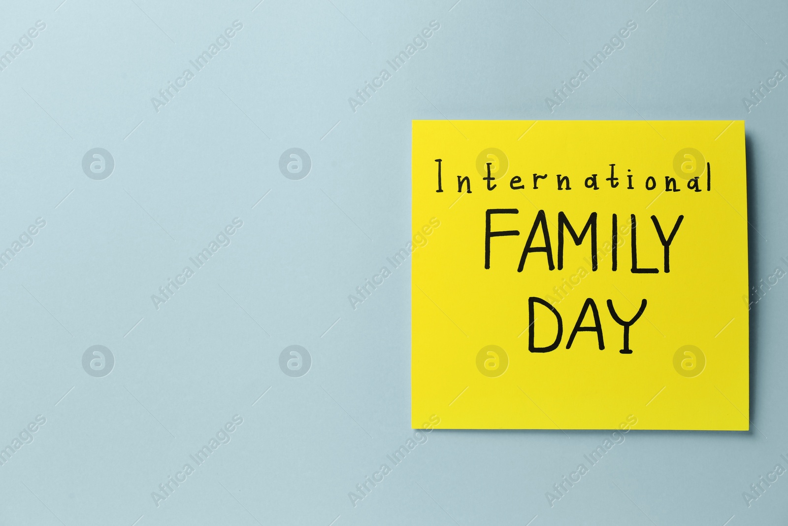 Photo of Card with words International Family Day on grey background, top view. Space for text