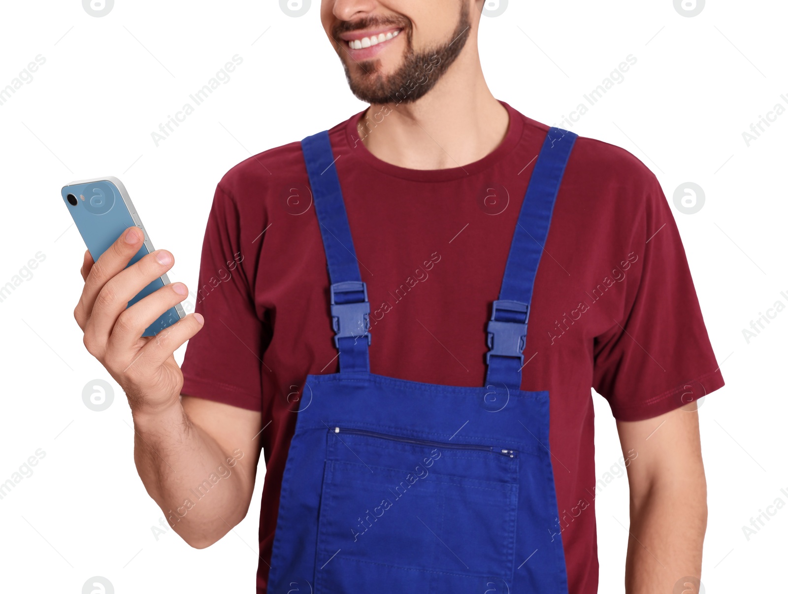 Photo of Professional repairman in uniform with phone on white background, closeup