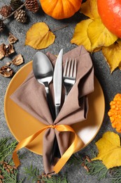 Happy Thanksgiving day. Beautiful table setting and autumn decoration on grey background, flat lay