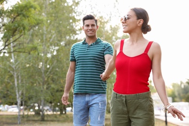 Photo of Lovely couple walking together in park on sunny day