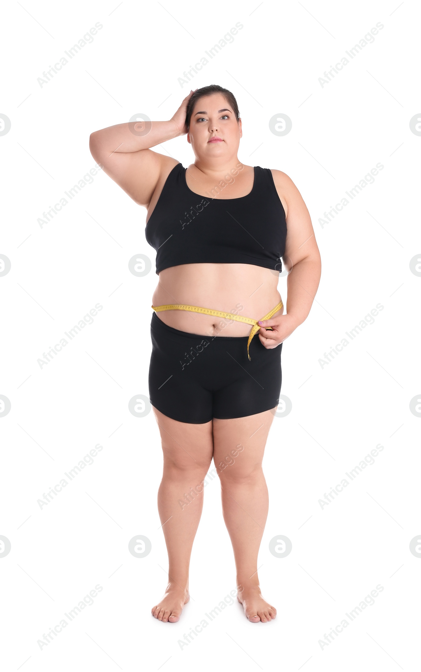 Photo of Overweight woman measuring waist before weight loss on white background