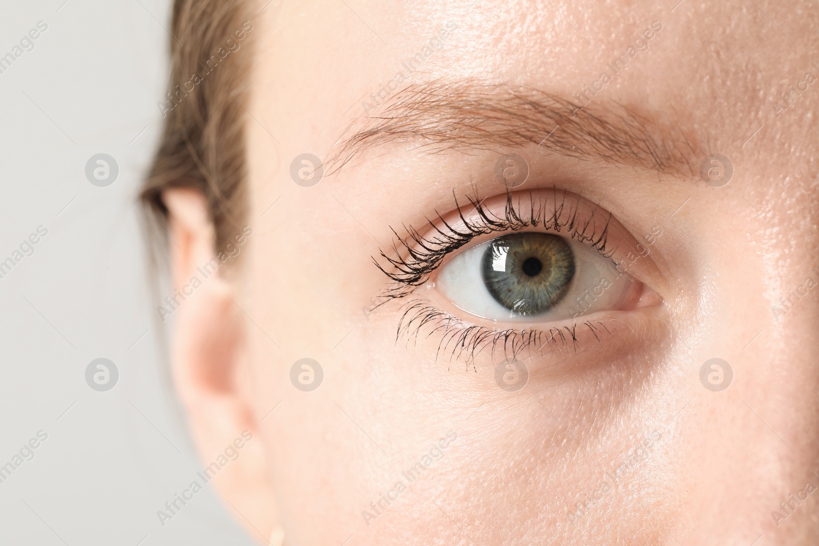 Photo of Closeup photo of woman with beautiful eyes on light background