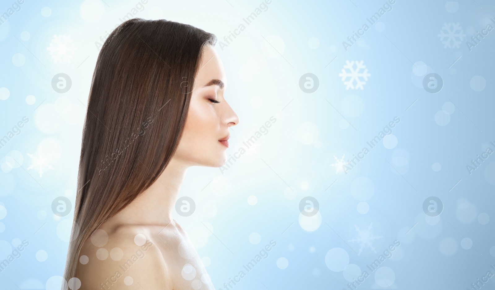 Image of Young woman with perfect smooth skin on light blue background, bokeh effect. Space for text