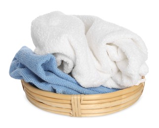 Wicker basket with crumpled bath towels isolated on white