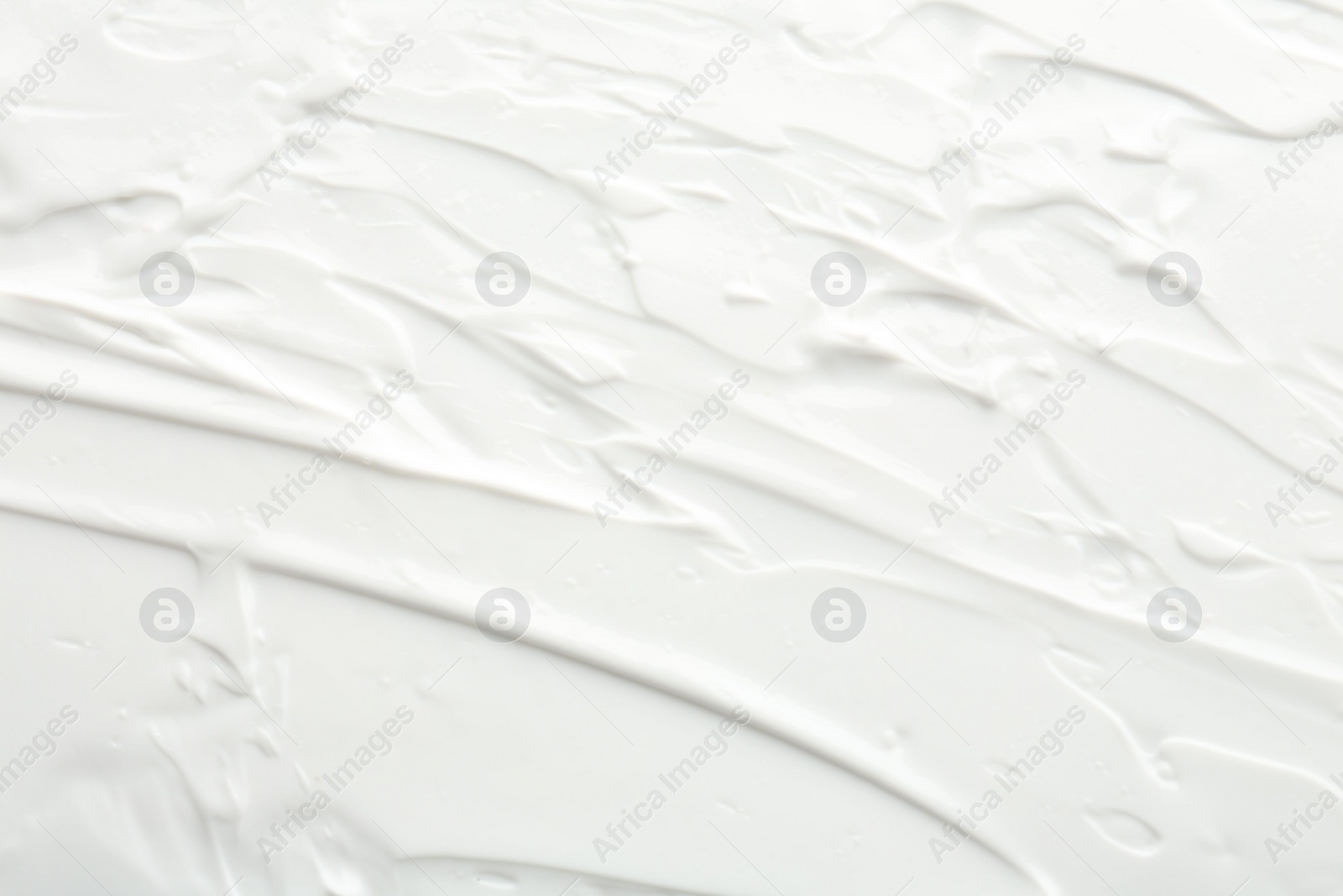 Photo of Texture of face care cream as background, top view