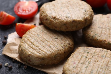 Photo of Tasty vegan cutlets and products on grey table, closeup
