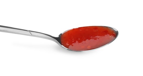 Photo of Spicy chili sauce in spoon isolated on white