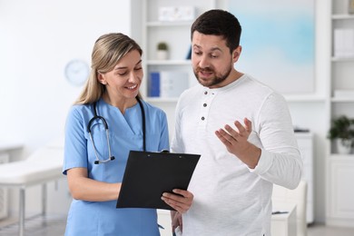 Photo of Professional doctor working with patient in hospital