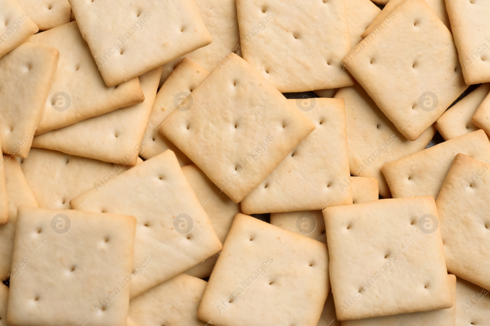 Photo of Many delicious crackers as background, top view