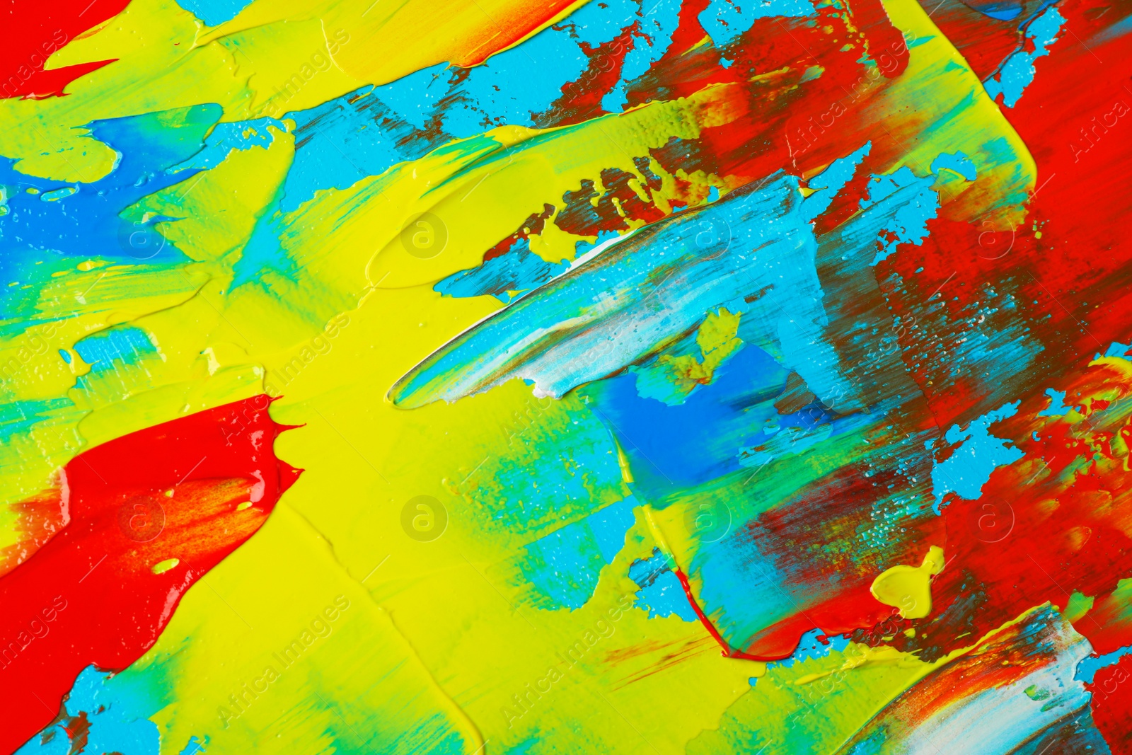 Photo of Closeup view of artist's palette with mixed bright paints as background