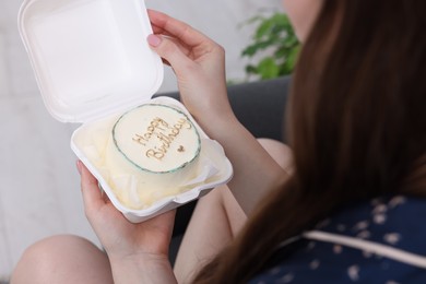 Photo of Woman holding her Birthday cake indoors, closeup