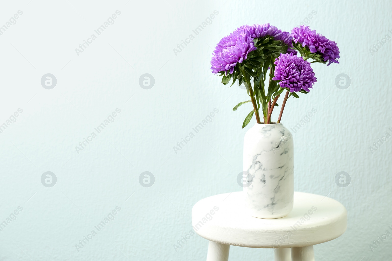 Photo of Bouquet of beautiful asters on table, space for text. Autumn flowers