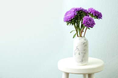 Photo of Bouquet of beautiful asters on table, space for text. Autumn flowers