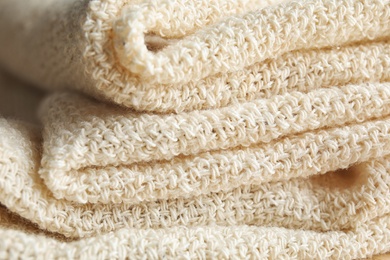 Closeup view of folded natural hemp cloth. Fabric texture