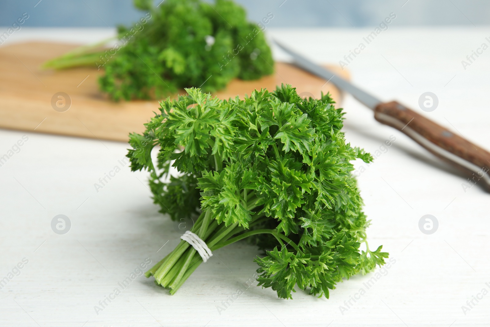 Photo of Bunch of fresh green parsley on wooden table