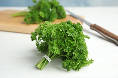 Photo of Bunch of fresh green parsley on wooden table