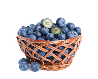 Photo of Fresh tasty blueberries in wicker basket isolated on white