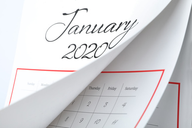 Photo of January 2020 calendar with turning pages as background, closeup