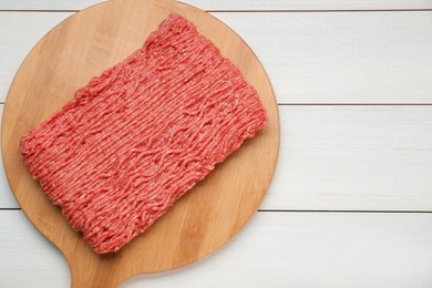 Raw fresh minced meat on white wooden table, top view. Space for text