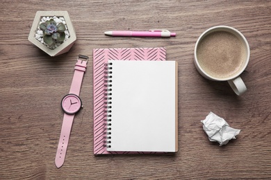 Photo of Flat lay composition with office stationery and cup of coffee on wooden table. Space for design