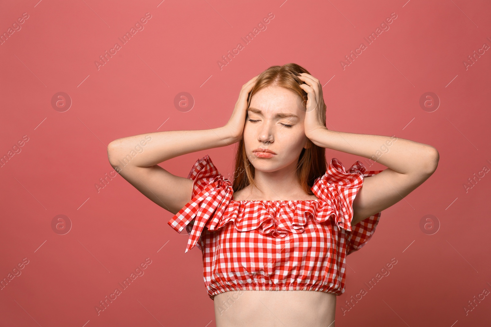 Photo of Portrait of upset young woman on pink background