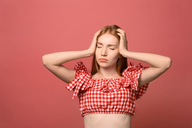 Photo of Portrait of upset young woman on pink background