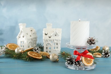 Photo of Christmas composition with glass candlestick on light blue table