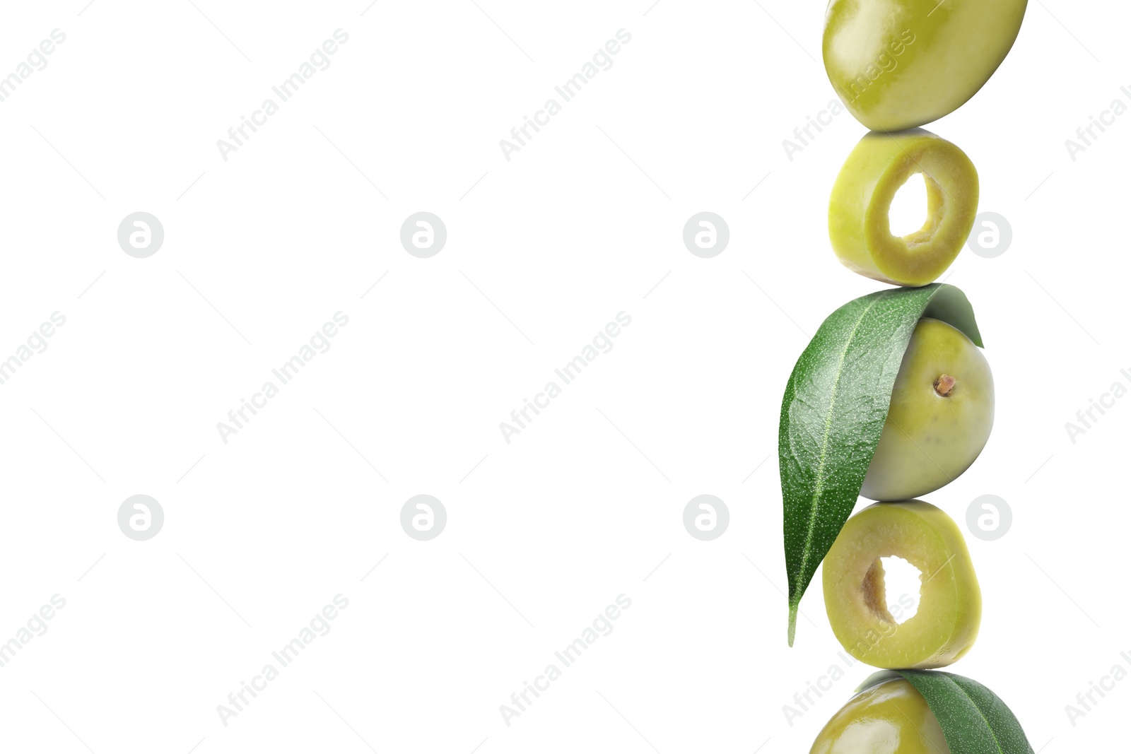 Image of Cut and whole green olives with leaves on white background