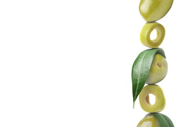 Image of Cut and whole green olives with leaves on white background