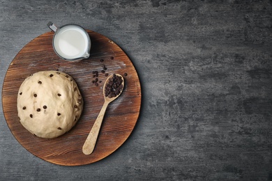 Photo of Flat lay composition with raw dough, milk and chocolate chips on grey background