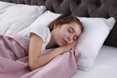 Photo of Beautiful little girl sleeping in bed at home