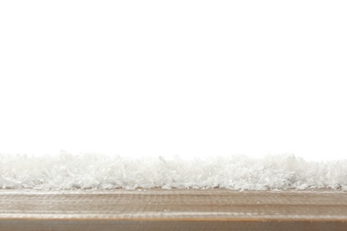 Photo of Snow on wooden surface against white background. Christmas season